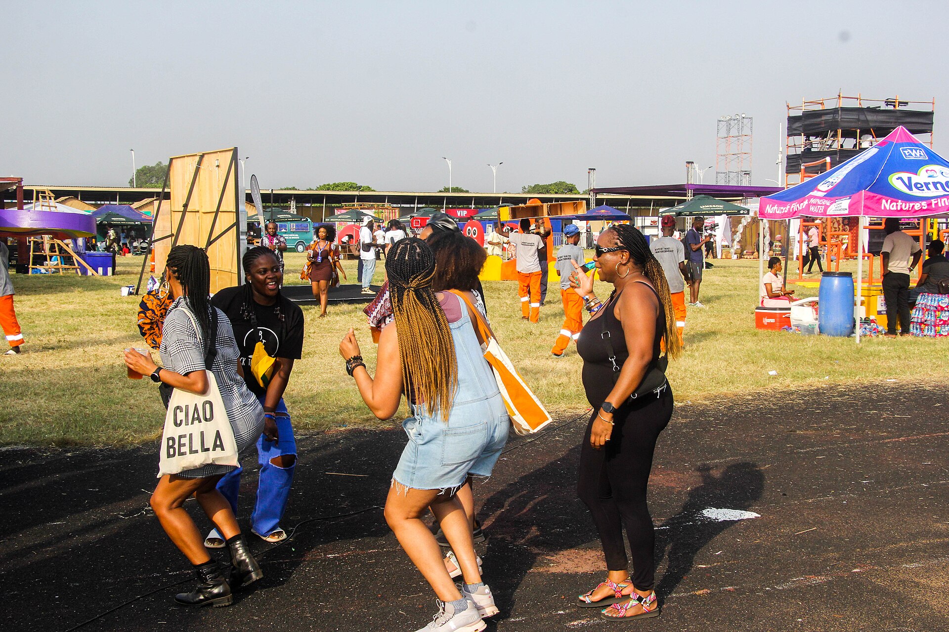 Festival-goers dancing on the grounds among food trucks and shaded stalls at the AfroFuture festival in Accra, Ghana, part of the country’s December festive season