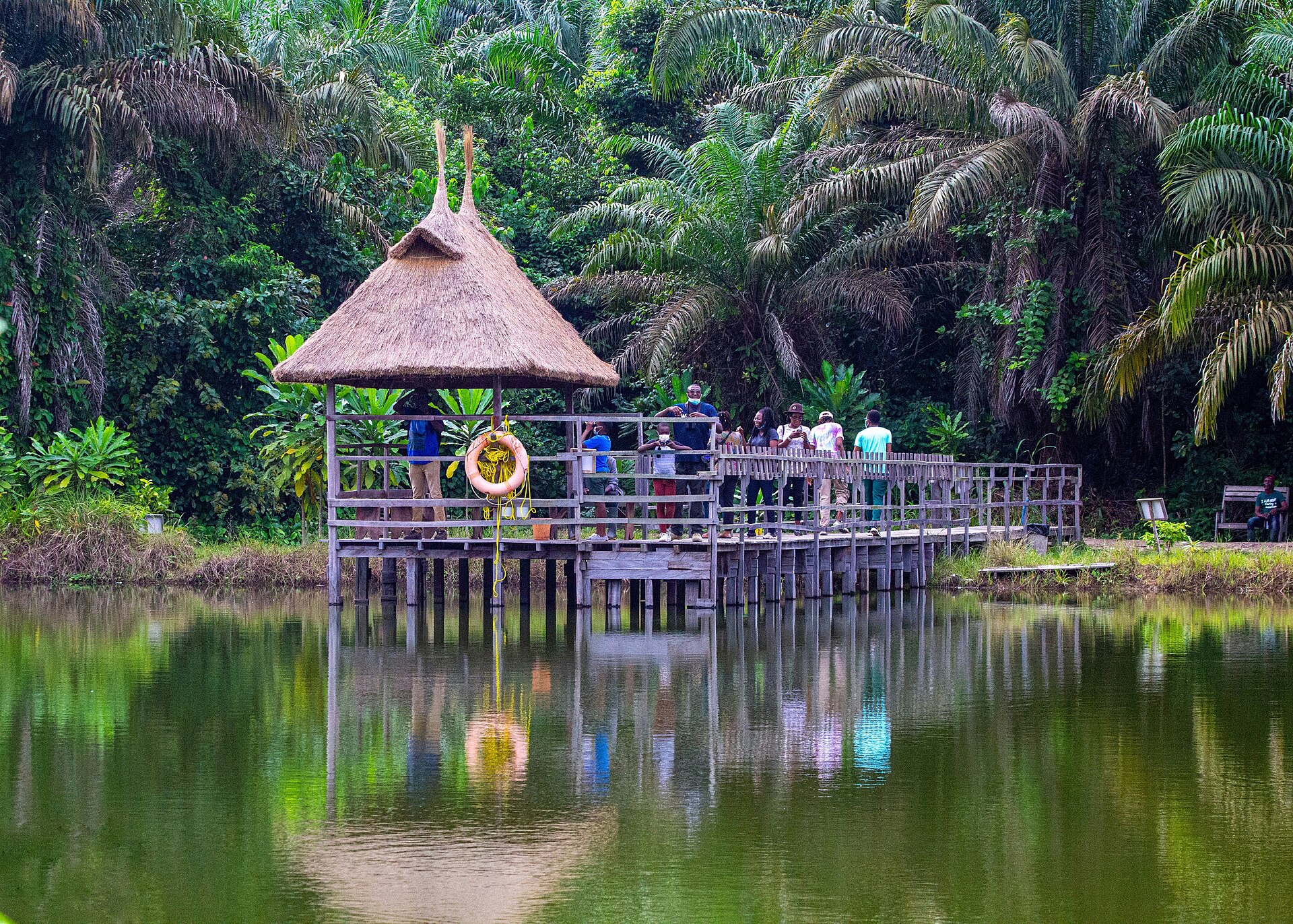 Lake Moses at Lufasi Nature Park, Lagos, with a thatched pier pavilion reflected in the water